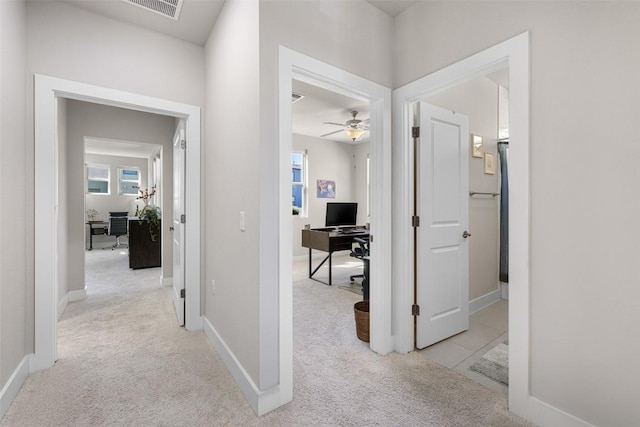 2505 Moreno St, Austin, TX 78723 - corridor featuring a desk, light carpet, and baseboards