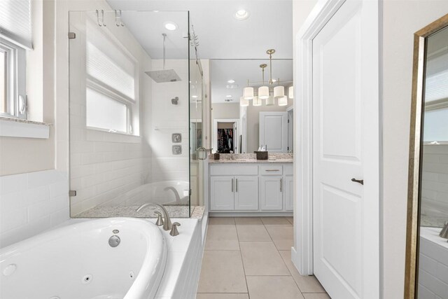 2505 Moreno St, Austin, TX 78723 - full bathroom with a stall shower, vanity, a whirlpool tub, and tile patterned floors