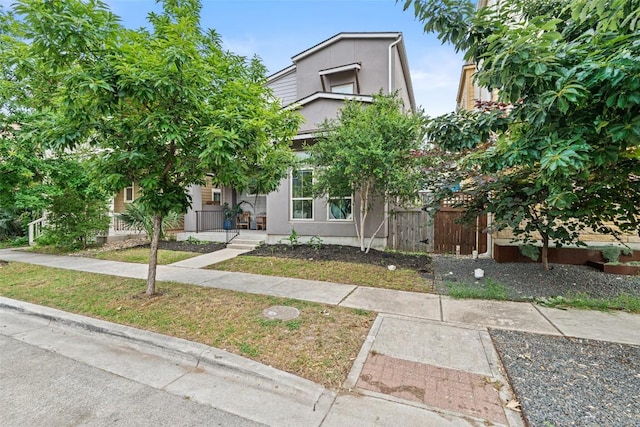 2505 Moreno St, Austin, TX 78723 - view of front of home with stucco siding, a gate, and a porch