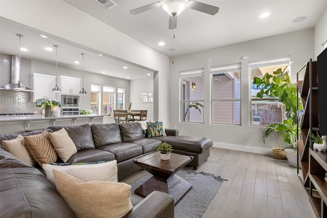 2505 Moreno St, Austin, TX 78723 - living area featuring light wood-style floors, recessed lighting, ceiling fan, and baseboards