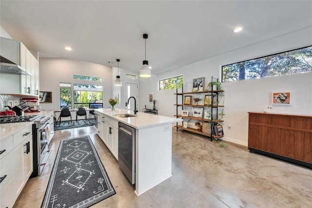 kitchen featuring a center island with sink, a sink, white cabinetry, stainless steel appliances, and light countertops