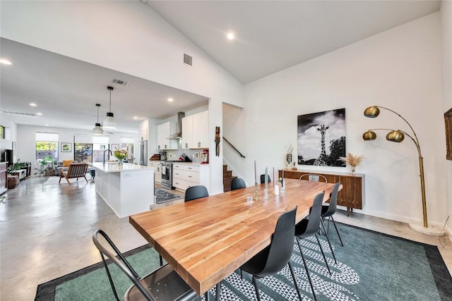 dining area featuring recessed lighting, finished concrete flooring, and visible vents