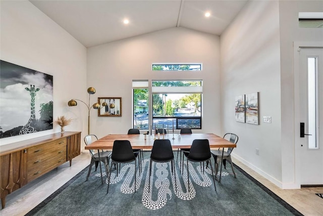 dining room featuring recessed lighting, baseboards, and high vaulted ceiling