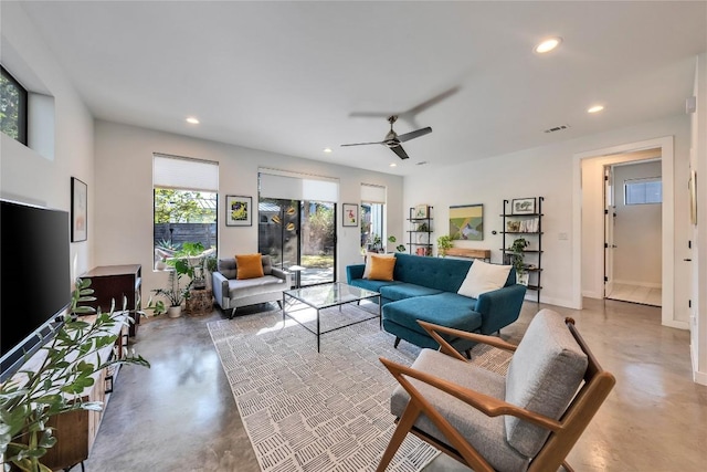 living area featuring visible vents, a ceiling fan, recessed lighting, concrete floors, and baseboards