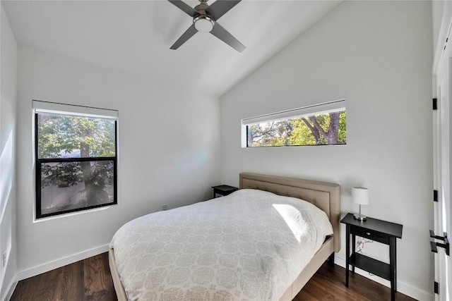 bedroom featuring ceiling fan, baseboards, lofted ceiling, and dark wood finished floors