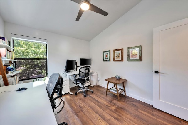 home office featuring wood finished floors, a ceiling fan, baseboards, and vaulted ceiling