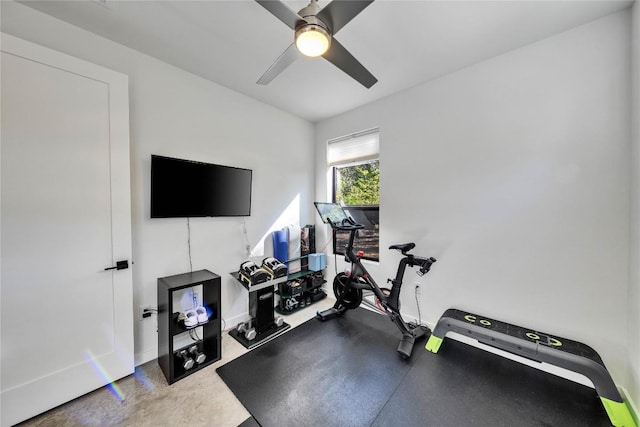 exercise area featuring baseboards and ceiling fan