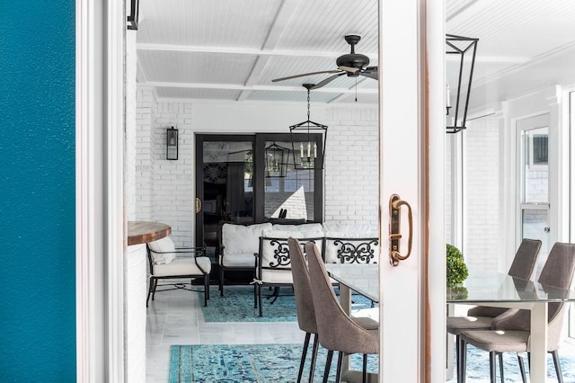 tiled dining area with brick wall and ceiling fan