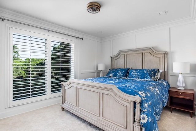 bedroom featuring light carpet, crown molding, and a decorative wall