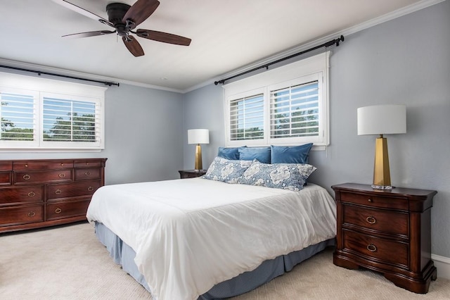 bedroom featuring light colored carpet, crown molding, and a ceiling fan