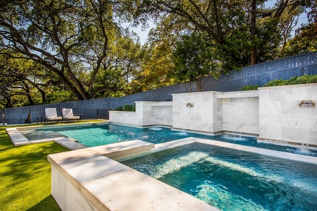 view of swimming pool with an in ground hot tub, a fenced backyard, and a fenced in pool