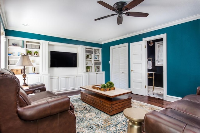 living room with ceiling fan, dark wood-type flooring, built in features, and ornamental molding