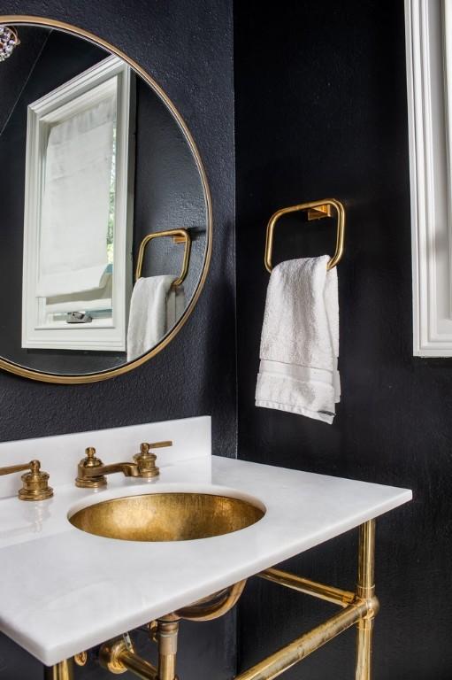 bathroom featuring a textured wall and a sink