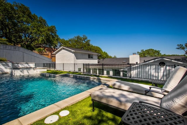 view of swimming pool with a fenced in pool and fence