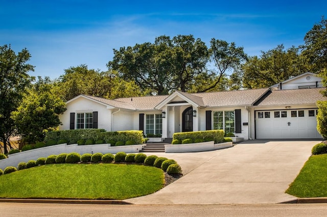 ranch-style house with concrete driveway, brick siding, and a garage