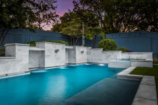 view of pool featuring a fenced in pool, an in ground hot tub, and a fenced backyard