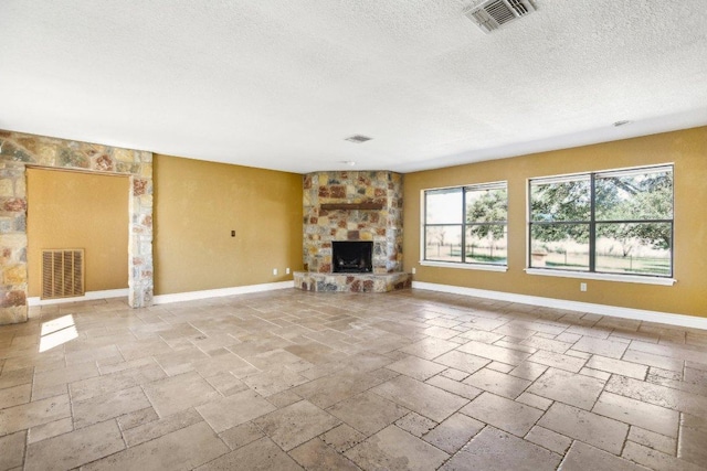 unfurnished living room with visible vents, baseboards, and a fireplace