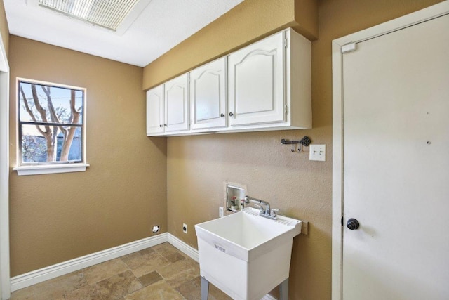 laundry room with baseboards, washer hookup, cabinet space, hookup for an electric dryer, and a sink