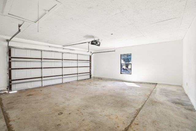 parking deck featuring a garage door opener and baseboards