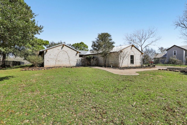 single story home with brick siding and a front lawn