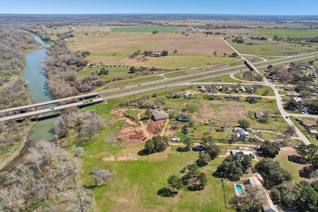 drone / aerial view featuring a rural view and a water view