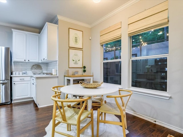 dining area featuring dark wood-style floors, baseboards, and ornamental molding