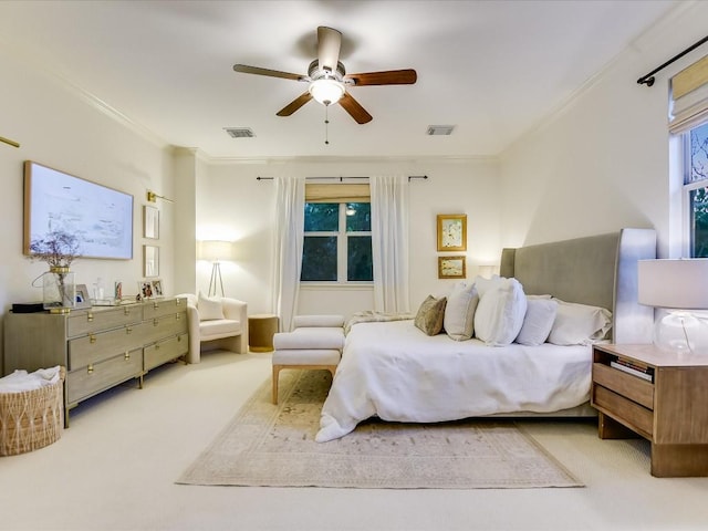 carpeted bedroom featuring visible vents, ceiling fan, and crown molding