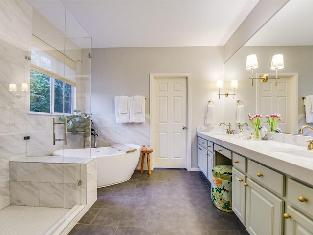 bathroom with a shower stall, double vanity, a soaking tub, tile walls, and a sink