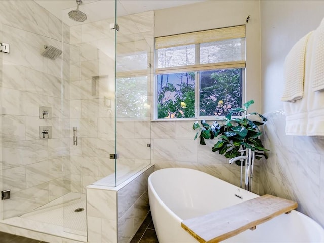 bathroom featuring a shower stall and tile walls