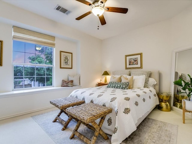 carpeted bedroom featuring visible vents and ceiling fan