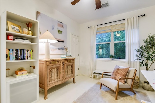 sitting room featuring light carpet, visible vents, and ceiling fan