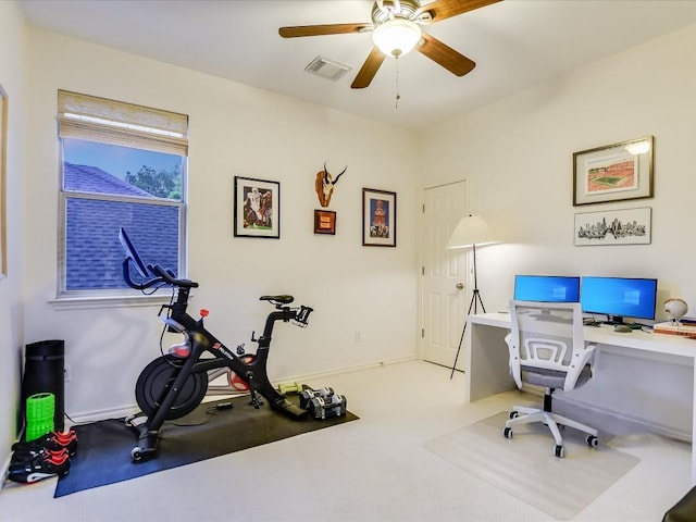 carpeted office space with baseboards, visible vents, and ceiling fan