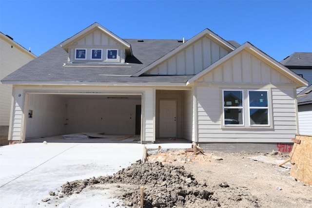 view of front facade featuring concrete driveway, an attached garage, and board and batten siding