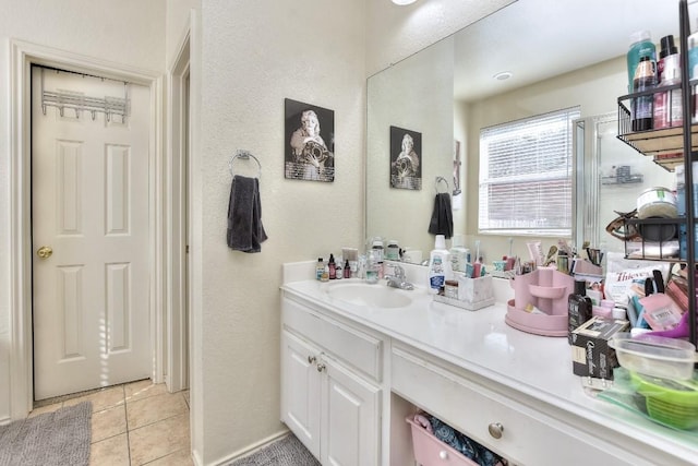 bathroom featuring tile patterned flooring and vanity