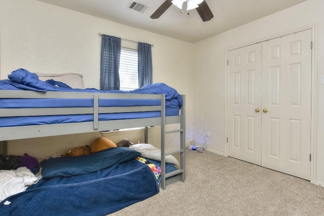 bedroom featuring visible vents, a closet, ceiling fan, and carpet flooring