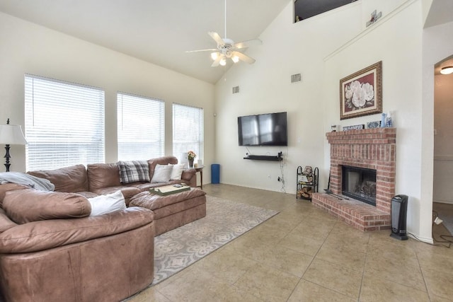 living room featuring visible vents, high vaulted ceiling, light tile patterned flooring, a fireplace, and ceiling fan