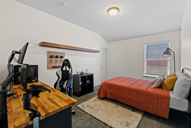 carpeted bedroom with lofted ceiling