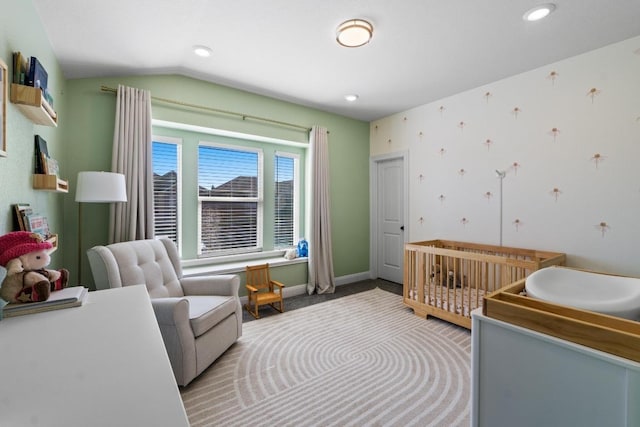 carpeted bedroom with baseboards, wallpapered walls, recessed lighting, a crib, and vaulted ceiling