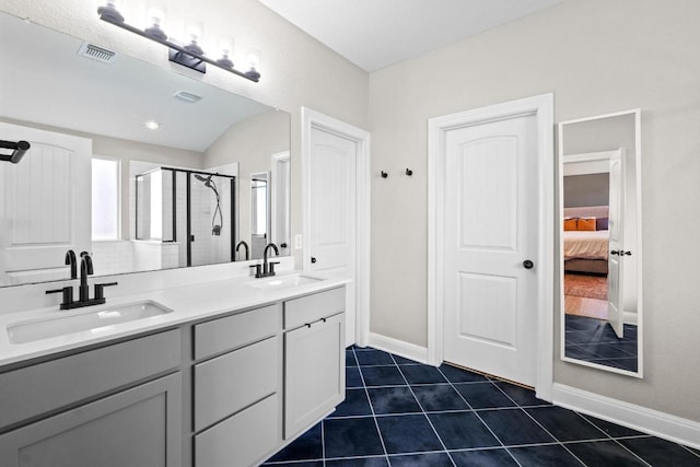 bathroom with a shower stall, visible vents, tile patterned floors, and a sink