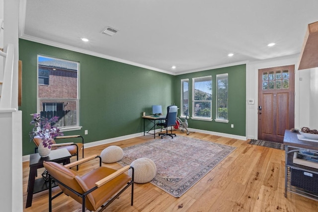 home office featuring visible vents, crown molding, baseboards, and wood finished floors