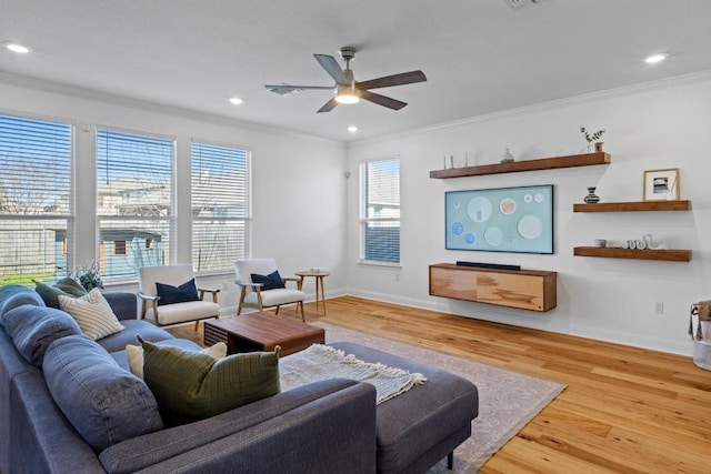 living room featuring ceiling fan, baseboards, ornamental molding, recessed lighting, and wood finished floors