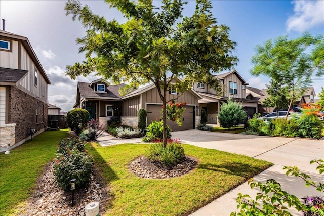 view of front of property with board and batten siding, a front lawn, fence, a garage, and driveway