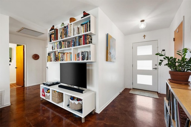 foyer with baseboards, visible vents, and concrete floors