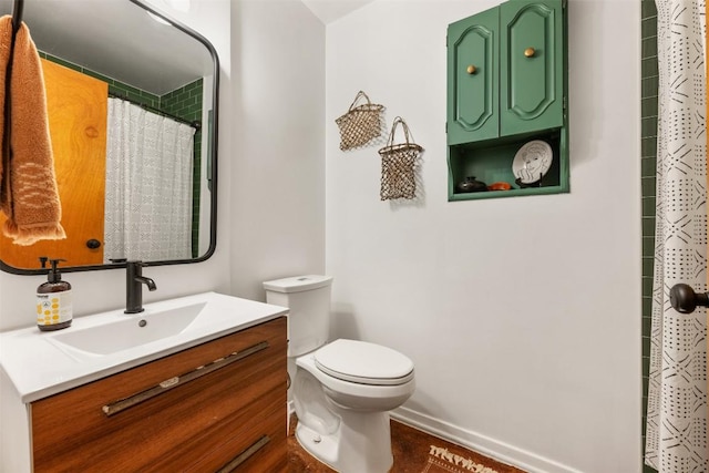 bathroom featuring vanity, curtained shower, toilet, and baseboards