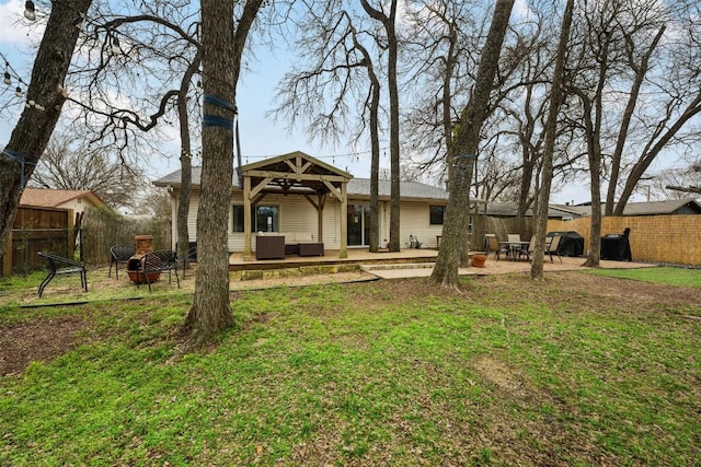 exterior space with a patio, fence, a yard, an outdoor living space with a fire pit, and a gazebo