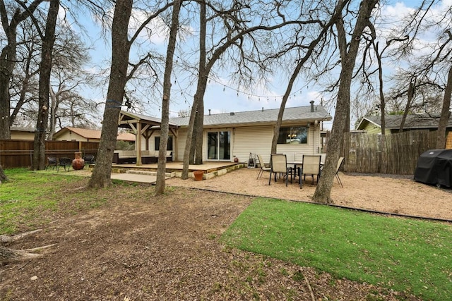 rear view of property with a patio area and fence