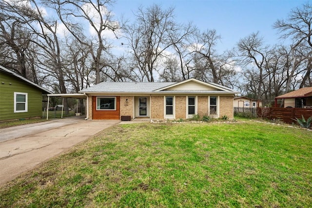 single story home with brick siding, fence, a front yard, a carport, and driveway