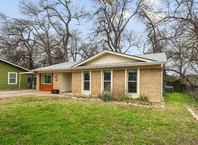 single story home with a front lawn, brick siding, and roof with shingles