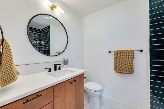 bathroom with baseboards, toilet, marble finish floor, and vanity