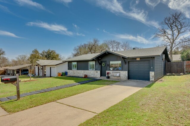 905 Turtle Creek Blvd, Austin, TX 78745 - ranch-style home featuring a garage, stone siding, and driveway